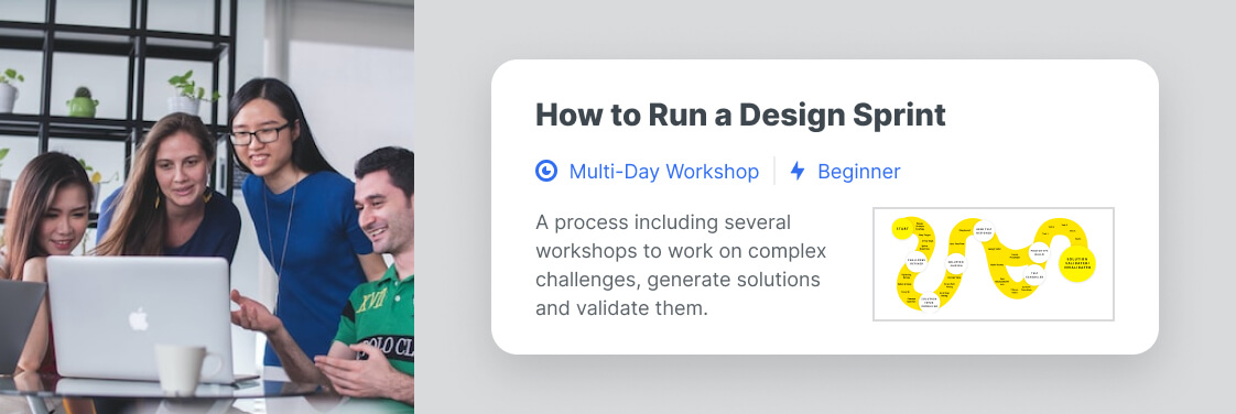 People behind a computer looking at the 'How to Run a Design Sprint' resource